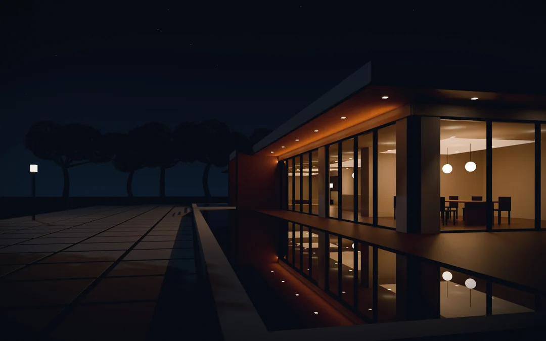 The same house after dark: warm rooms lit behind the glass, mirrored in the pool